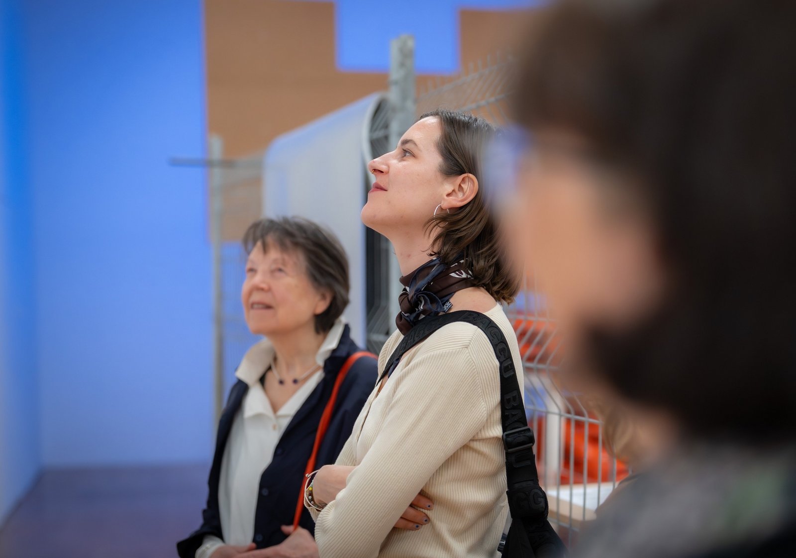 Two women of different ages in an exhibition