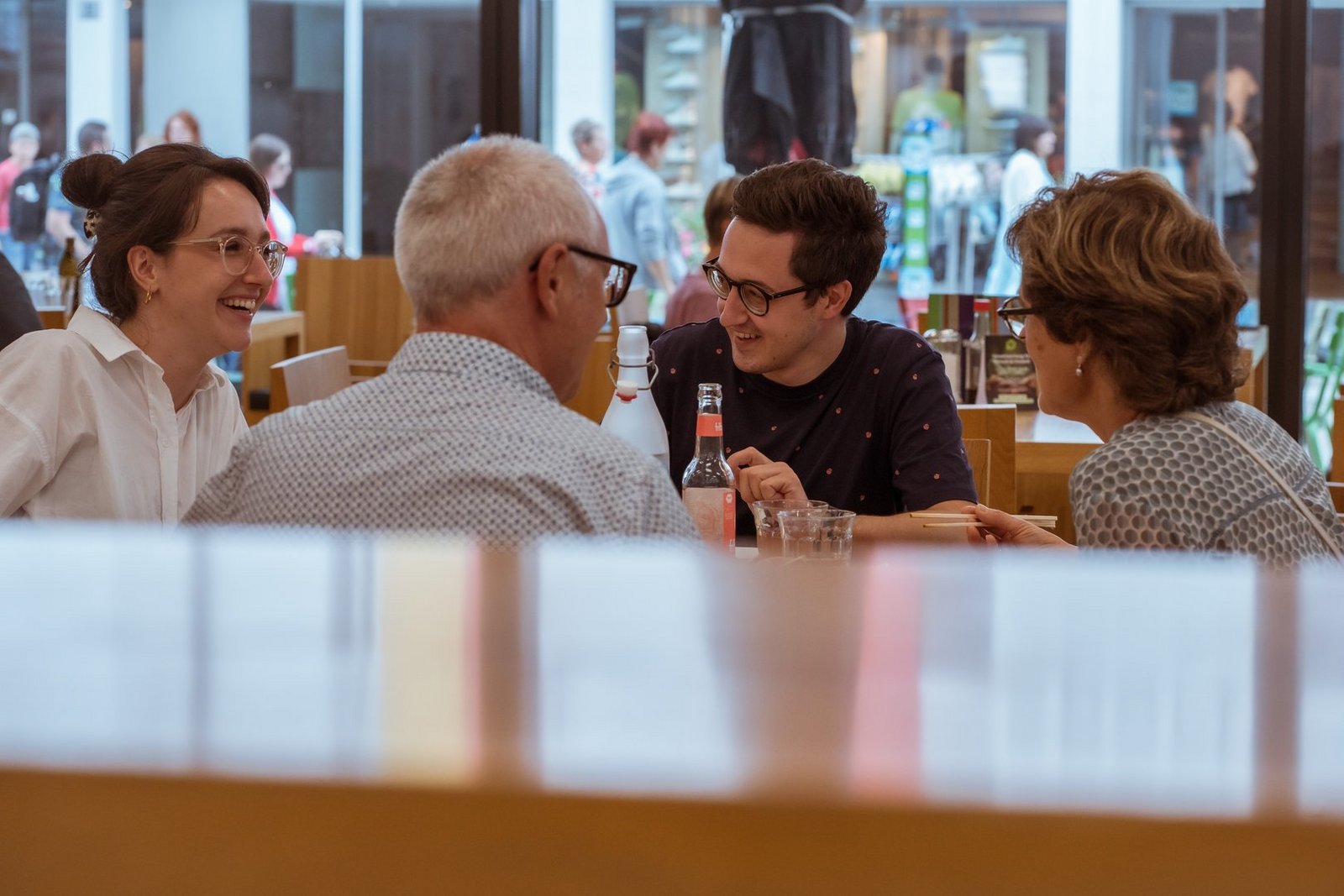 eine Gruppe Personen sitzen bei einem Esstisch